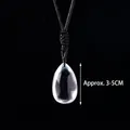 Detailed view of teardrop crystal pendant with black cord, measuring approx. 3-5cm - Clear Quartz Teardrop Hand-woven Cord