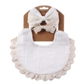 Close-up of baby bib set with cotton lace headband on cardboard packaging - White