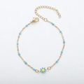 Detail of 18K gold daisy bracelet featuring blue enamel petals and bead chain accents - Gold + Lake Blue