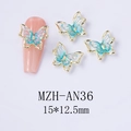 Macro detail of laser butterfly nail charms with gold borders and blue resin inlay - Blue Gold Style (AN36)