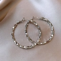 Detailed macro view of silver hoop earrings with faceted texture on silk fabric background - Rhombus Textured Hoop / Silver