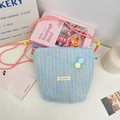 Light blue textured crossbody phone bag with colorful stripes and adjustable strap - Blue