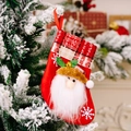 Weihnachtssocke mit Weihnachtsmann-Motiv und Karomuster am Weihnachtsbaum - Weihnachtsmann