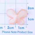 Pink glitter resin butterfly charm for DIY phone cases and hair accessories 1.8cm - Orange