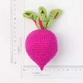 Handmade knitted pink radish keychain ornament showing dimensions with a ruler - Rose Red Knitted Carrot