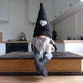 Nordic knitted gnome decoration with black heart hat and coffee cup on books - Right Hand Coffee Male Gnome / Black