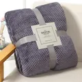 Lavender purple waffle textured flannel blanket neatly folded with grey ribbon on sofa - Smoky Purple
