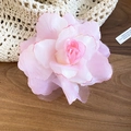 Close-up detail of a soft pink fabric mesh flower hair clip on wooden surface - Large Pink Rose Mesh Duckbill Clip (15#) / Pink