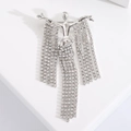 Elegant silver figure brooch with shimmering rhinestone tassels on white display stand - Tassel Humanoid / Silver