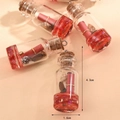 Detailed view of 4.3cm mini glass wishing bottle with shell and red scroll charms - Red Drifting Bottle