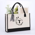 Cream canvas tote bag with black letter T, summer vibe print and a striped bow charm - Letter-T