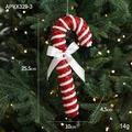 Red and white glittery Christmas candy cane ornament with a bow and berry on a tree - Candy Cane Style D