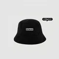 Thick black faux lamb wool bucket hat for women with embroidered letter patch detail - M (56-58cm) / Black