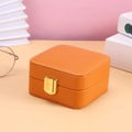 Portable orange leather jewelry storage box with golden metal clasp for necklaces - Pumpkin Orange