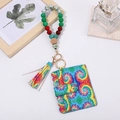 Detail of tie-dye PU card holder with colorful beaded wristlet and tassel keychain charm - Rainbow Tie Dye