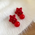 Close-up of red polka dot star fabric earrings with glossy spherical drop on soft textile - Glossy Ball Drop / Silver Pin - Red Smooth Surface