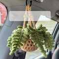 Handmade crochet hanging plant car ornament with green leaves and beige pot on a hook - Khaki Basket + Army Green Banana Leaves