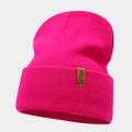 Detail of hot pink ribbed knit beanie featuring a brown leather patch with text - Rose Red