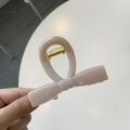 Detail of nude bow hair claw clip showing golden metal spring and smooth matte texture - Medium 8cm / Light Nude Pink