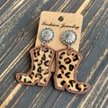Leopard print cowboy boot earrings with silver flower studs on a dark wood background - Leopard Print