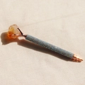 Macro view of rose gold ballpoint pen with rainbow rhinestones and yellow crystal top - Citrine / Black Ink