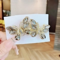 Elegant gold butterfly hair clip with grey crystals on a handmade jewelry card - Double Butterfly Grey Spring Clip