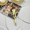 Close-up of golden acrylic I Love You cake topper with a kissing couple silhouette - Kissing Couple - I Love You