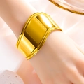Macro view of wide 18k gold plated stainless steel cuff with a polished wavy surface - Thin Open Bangle / Gold
