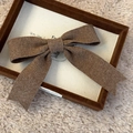 Close-up of the coffee brown knitted bow hair clip featuring a refined ribbed texture - Brown