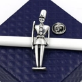 Close-up of silver Nutcracker soldier brooch with rhinestones on blue textured gift box - Nutcracker Style (XD8175 Clasp)