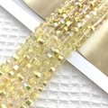 Macro detail of 8mm faceted yellow crystal beads with iridescent coating for DIY jewelry - Bright Gold