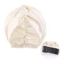 Detail of adjustable elastic strap and buckle on cream faux silk twisted sleeping bonnet - Beige