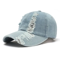 Detailed view of light blue distressed denim baseball cap with stylish frayed holes - Adult / Light Blue