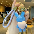 Blue knit-texture rabbit keychain with pink heart and purple strap held in hand - Resin Heart Rabbit-Purple