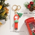 Close-up of Christmas tree nail clipper keychain with red finish and festive ornaments - Christmas Tree with Colorful Stones