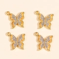 Primo piano di quattro ciondoli a farfalla dorati con strass per la creazione di gioielli - Farfalla Oro (Stile 1)