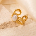 Detailed macro view of an oval opal-like gemstone on a braided gold ring band - Braided White Iridescent Stone Adjustable Style (TYR0713)