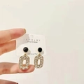 Macro shot of 925 silver post geometric earrings with rhinestones on a card - Gold Base Black Circle Clear Zirconia Dangle (A51 White Diamond)