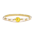 Gold metal bead and white pearl stretch bracelet featuring a yellow Hamsa Hand pendant - Yellow