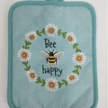 Light blue cotton heat insulation mat featuring daisy and bee embroidery with Bee happy text - Bee