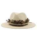 Detail of wide brim straw hat with brown feathers and golden skull charms decor - Beige