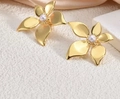 Detail of gold petal earrings with white pearls on a minimalist stone background - ED10-Realistic 5-Petal Flower