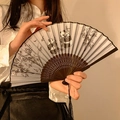 Classic folding fan with panda bamboo print, black carved ribs and silk tassel - Black & White Panda