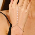 Elegant silver finger chain hand harness featuring white faux pearls on female hand - 14 White K 2293