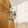 Detail of sweet plumeria hair claw clip with purple and green swirl on blonde hair - Style D Hollow (Purple-Green Marble)
