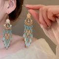Close-up of bohemian tassel earrings with turquoise beads and blue teardrop crystals - Blue (31# Ear Hook)
