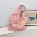 Close-up of pink floral quilted tote bag with sozakka beauté woven label and bear decor - Flower Yellow Rabbit