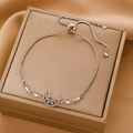 Close-up of adjustable silver star and moon bracelet with rhinestones on silk - White Gold Star Moon Bolo Bracelet (8851)