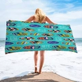 Detail of a microfiber beach towel featuring teal tropical surfboard and flamingo prints - Cyan Surfing