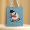 Detailed close-up of a blue Christmas canvas tote bag featuring a snowman on a sled print - Style 21